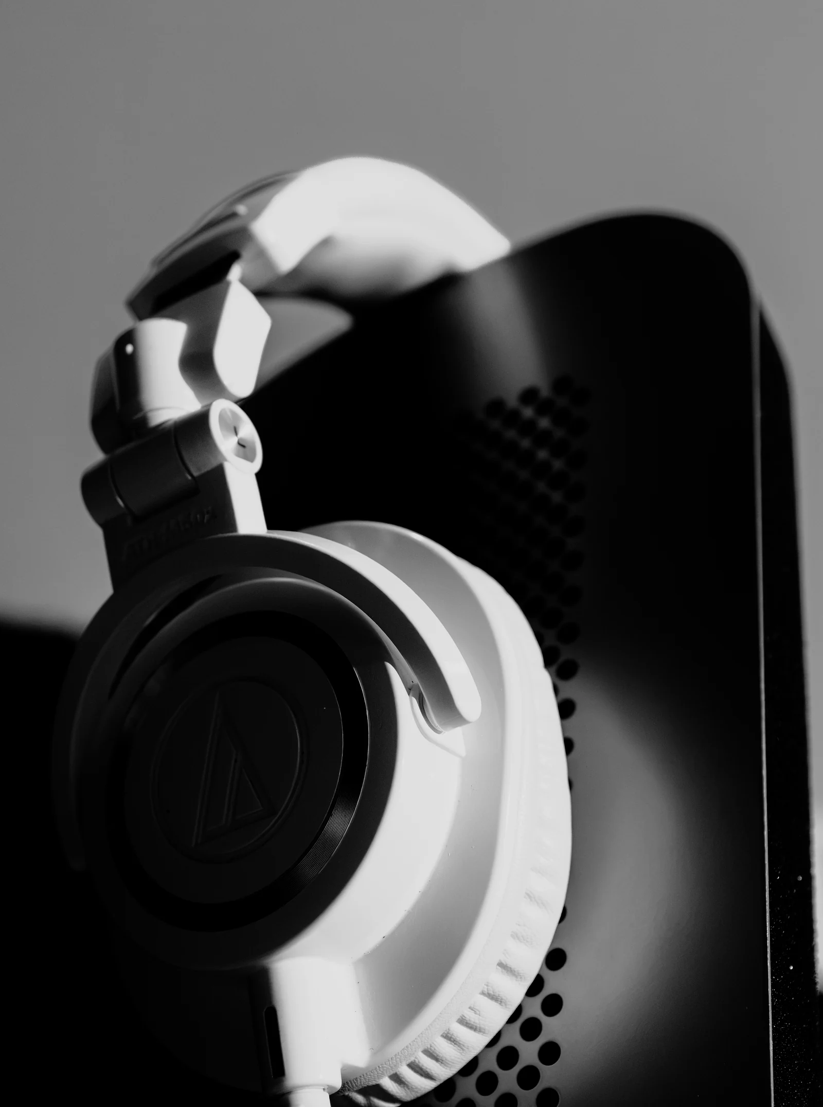 Headphones resting on the edge of a studio monitor.